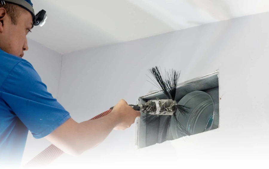 Manual Air Duct Brushing – "Technician brushing out dust and buildup from an air duct vent during a routine residential air duct cleaning service in Nj."